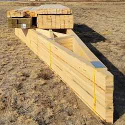 A lumber package sitting on a construction site